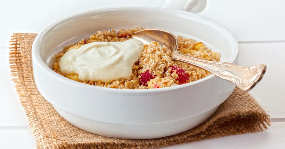 A bowl of Apple-Raspberry Crumble with Greek yogurt.