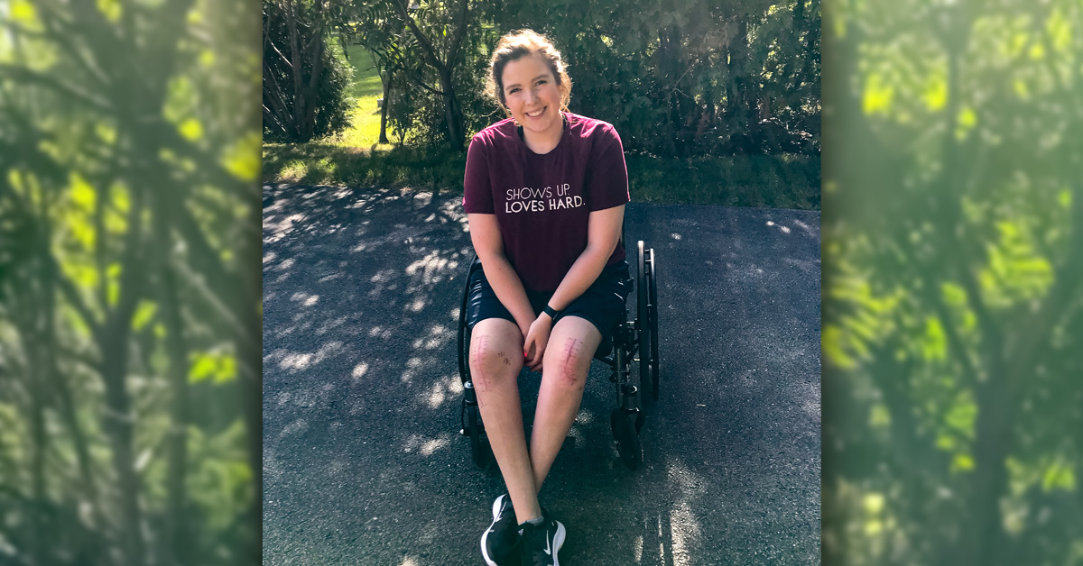 Emily smiling, sitting a wheel chair