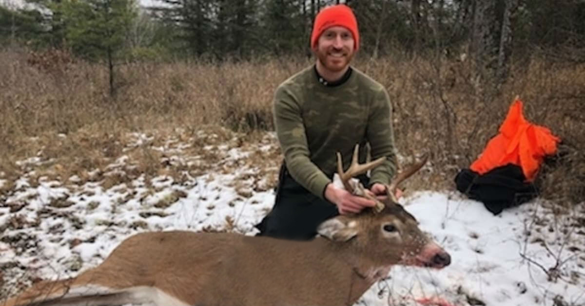 Dr. Ryan Woods poses with a deer he shot while hunting.