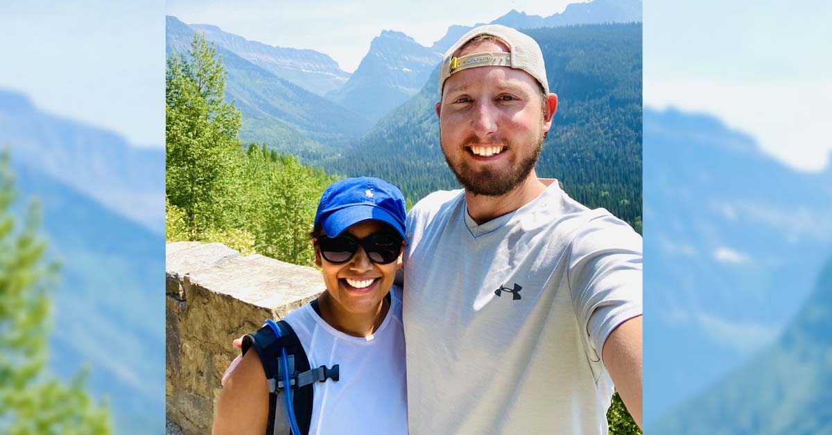 Dr. Ryan Clark of BayCare Clinic poses in front of a mountainous landscape with his fiancee, Dr. Puja Bhakta, also of BayCare Clinic.