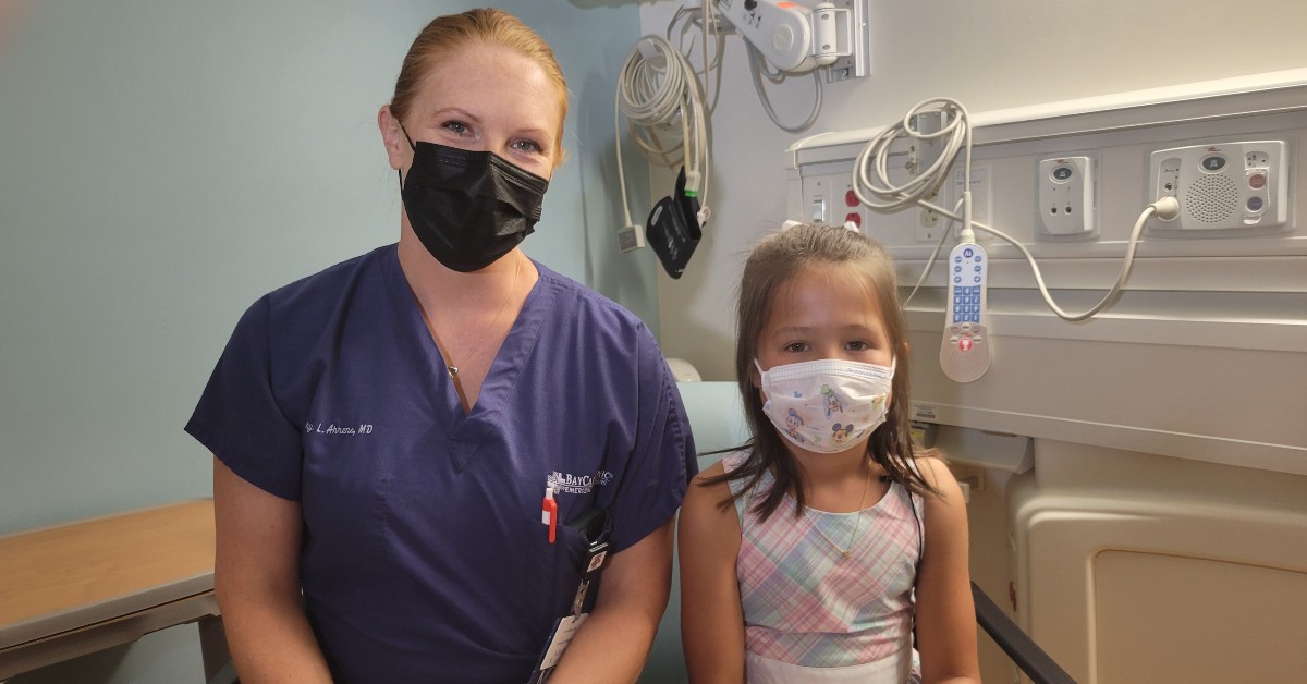 Dr Ahrens w young girl patient in an exam room