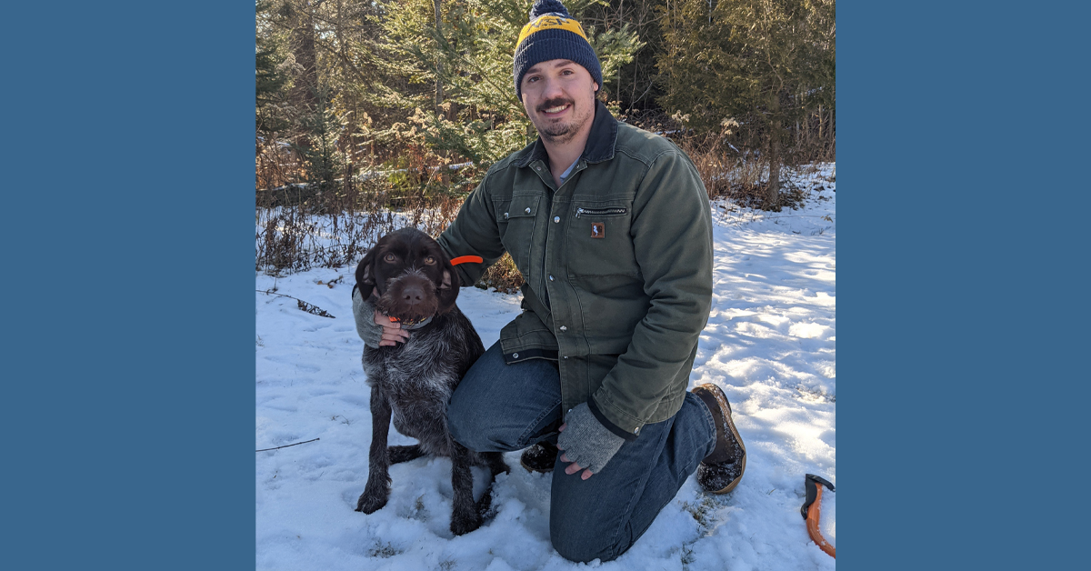 Dr. Dan Miller of BayCare Clinic poses with his dog, a Wirehaired Pointing Griffon