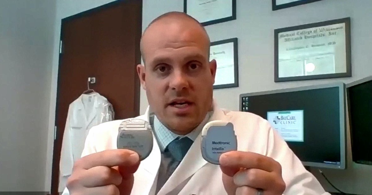 Dr. Christopher Howson of BayCare Clinic Pain & Rehab Medicine holds up a spinal cord stimulator.